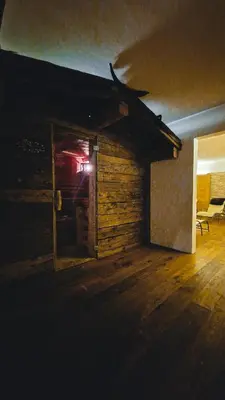 an open door to a room with a wooden floor at Solaia Hotel & Guesthouse in Castelrotto