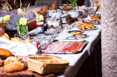 a long table with a buffet of food and bread at Solaia Hotel & Guesthouse in Castelrotto