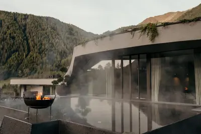 a fire pit in front of a building with a mountain at SILENA, your soulful hotel - adults only in Valles