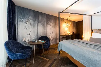 a bedroom with a bed and two chairs and a table at SILENA, your soulful hotel - adults only in Valles