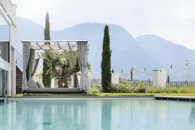 a gazebo next to a swimming pool at Small & Beautiful Hotel Gnaid in Tirolo