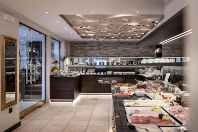 a kitchen with a counter with food on it at Small & Beautiful Hotel Gnaid in Tirolo