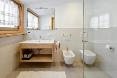 a bathroom with a sink and a toilet at Garni Charlotte in Selva di Val Gardena