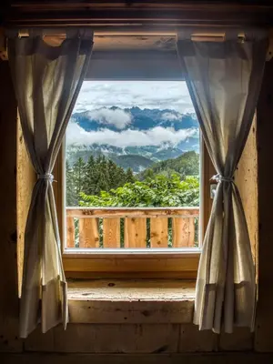 a window with a view of a mountain view at Natur Apartments Riesen in San Lorenzo di Sebato
