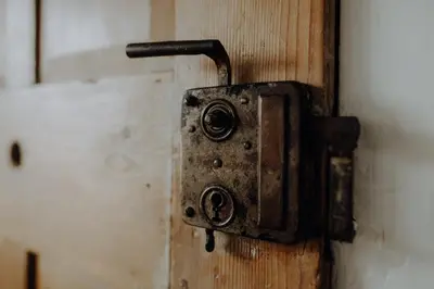an old rusty latch on a wooden door at Natur Apartments Riesen in San Lorenzo di Sebato