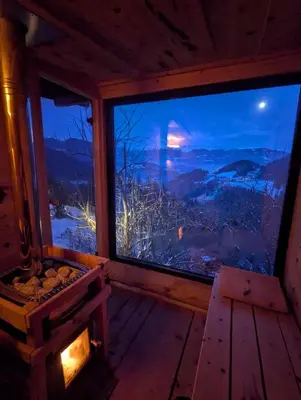 a room with a large window with a view of the mountains at Natur Apartments Riesen in San Lorenzo di Sebato