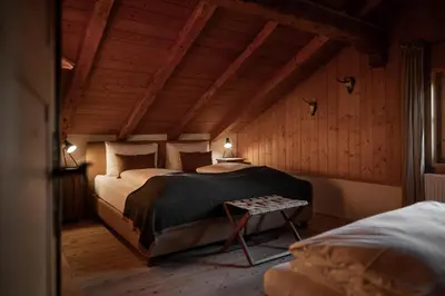 a bedroom with a bed and a table in it at Chalet Hafling Zoila in Avelengo
