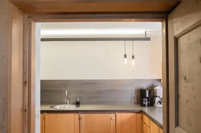 a kitchen with wooden cabinets and a sink at Chalet Hafling Zoila in Avelengo