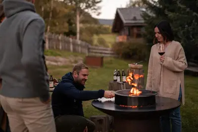 a man and a woman standing around a table with a cake at Chalet Hafling Zoila in Avelengo