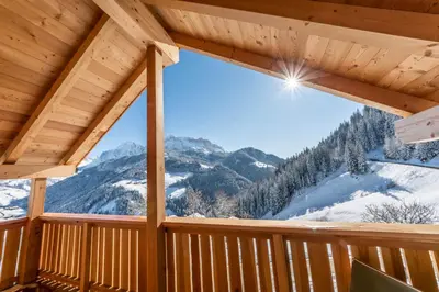 a view from the deck of a cabin with snow covered mountains at agriturismo Lüch Picedac in La Valle