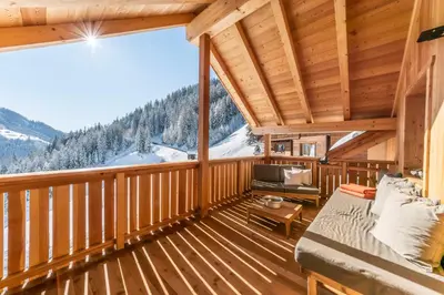 a living room with a couch on a wooden deck at agriturismo Lüch Picedac in La Valle