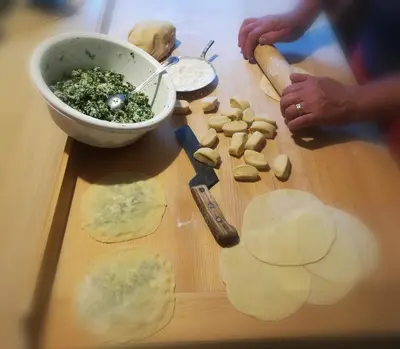 a person cutting up some food on a cutting board at agriturismo Lüch Picedac in La Valle