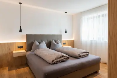 a bed with two pillows on it in a bedroom at Beim Lackl in Avelengo