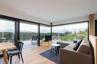 a living room with a couch and a large window at Beim Lackl in Avelengo