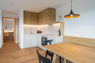 a kitchen and dining room with a wooden table at Beim Lackl in Avelengo
