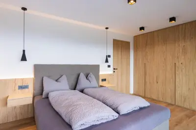 a bedroom with a large bed with white pillows at Beim Lackl in Avelengo