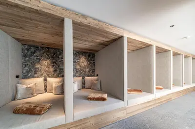 a room with two beds in the middle of it at Dolomites Nature Hotel Vigilerhof in Siusi