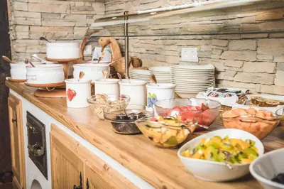 a counter with many bowls and dishes on it at Hotel Castel Oswald von Wolkenstein in Castelrotto