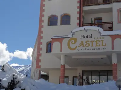 a hotel in the mountains with snow on the ground at Hotel Castel Oswald von Wolkenstein in Castelrotto