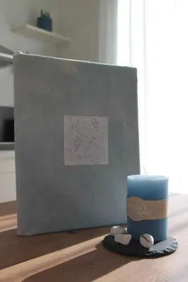 a candle sitting on a table next to a box at Residence die Färbe in Vipiteno