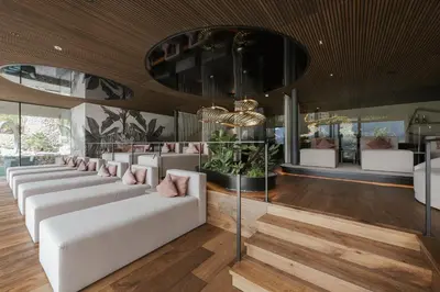 a living room with white couches and a chandelier at Feel good Resort Johannis in Tirolo