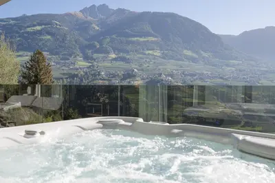 a hot tub with a view of a mountain at Feel good Resort Johannis in Tirolo