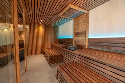 a sauna with wooden benches in a room at Feel good Resort Johannis in Tirolo