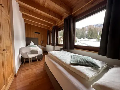 a large bedroom with a large bed in it at Garnì Villa Erna in Selva di Val Gardena