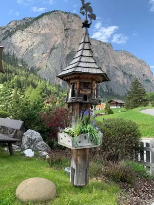 a dining room with two tables and windows at Garnì Villa Erna in Selva di Val Gardena