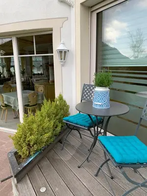 a table and chairs sitting on a porch at Garnì Villa Erna in Selva di Val Gardena