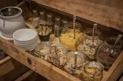a wooden shelf with jars of food and other items at Pension Moarhof in Feldthurns