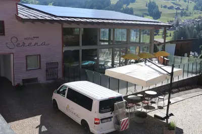 a white van parked in front of a building at Hotel Serena in Badia