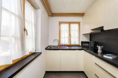 a kitchen with a sink and a microwave at Residence Rottonara in Corvara in Badia