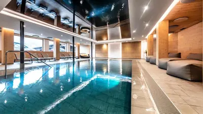 a swimming pool in a room with a couch at Martina Breakfast Lodge in Castelrotto
