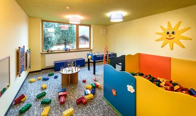 a room with a playroom with toys on the floor at Martina Breakfast Lodge in Castelrotto