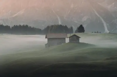 an old house on a hill in the fog at Sensoria Dolomites in Siusi