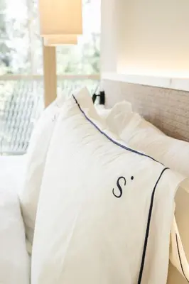 a white bed with a blanket on top of it at Sensoria Dolomites in Siusi