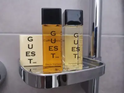 three bottles of oils sitting on a metal shelf at City Apartment 221 in Merano