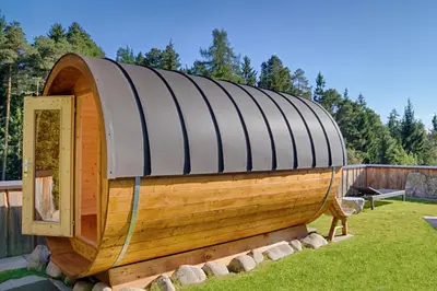 a large wooden boat sitting in a yard at APIPURA hotel rinner in Soprabolzano