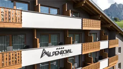 a building with a sign for the albuquerque hotel at Hotel Alpenroyal in Castelrotto