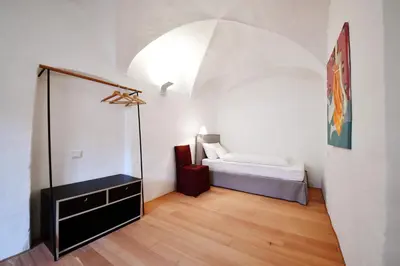 a bedroom with a bed and a mirror in a room at Casa Piganò in Appiano sulla Strada del Vino
