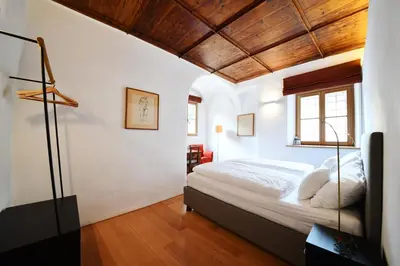 a bedroom with a bed and a wooden ceiling at Casa Piganò in Appiano sulla Strada del Vino