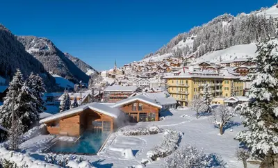 a resort in the mountains covered in snow at Family Hotel Posta in Santa Cristina in Val Gardena