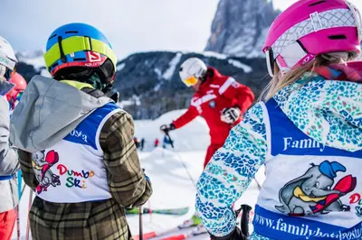 a group of people on skis in the snow at Family Hotel Posta in Santa Cristina in Val Gardena