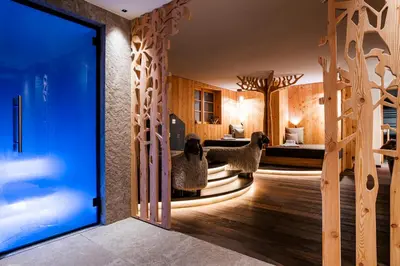 two sheep standing in a room with a bedroom at Family Hotel Posta in Santa Cristina in Val Gardena