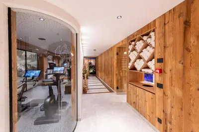 a hallway with wood paneling and a room with wine bottles at Hotel Arkadia - 