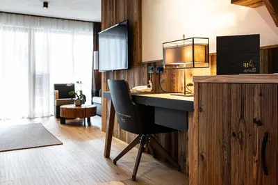 a kitchen with a desk and a chair in a room at Hotel Arkadia - 