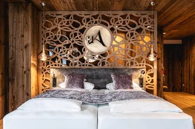 a bedroom with a bed with a clock on the wall at Hotel Arkadia - 