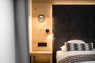 a bedroom with a bed and a wooden wall at Hotel Arkadia - 