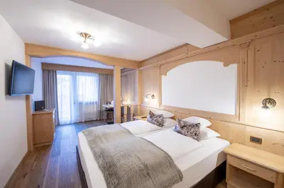 a bedroom with a large bed and a tv at Hotel Arkadia - 